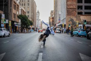 woman breakdancing on street