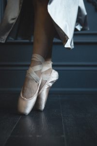 photo of woman wearing ballet shoes